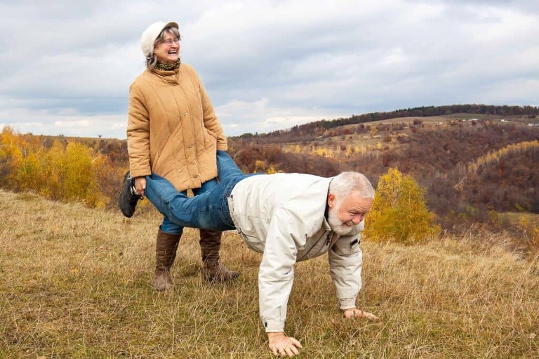 Woman and man in countryside free from sciatica.
