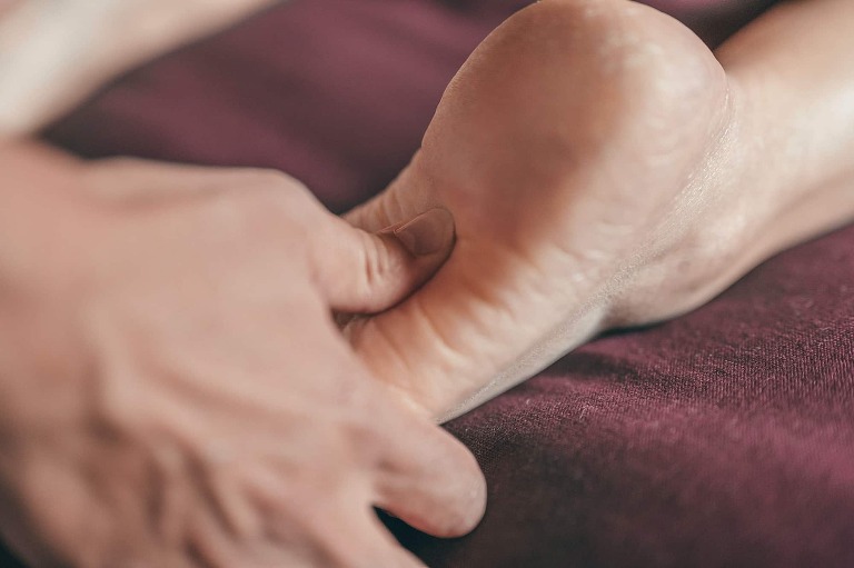 person receiving foot massage treatment for sciatica